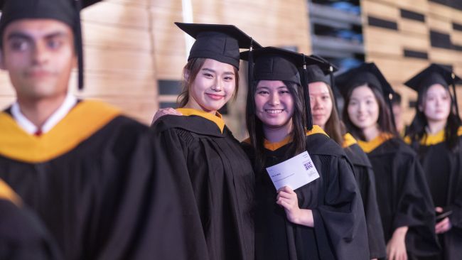 SCIS Graduand Hugging Father